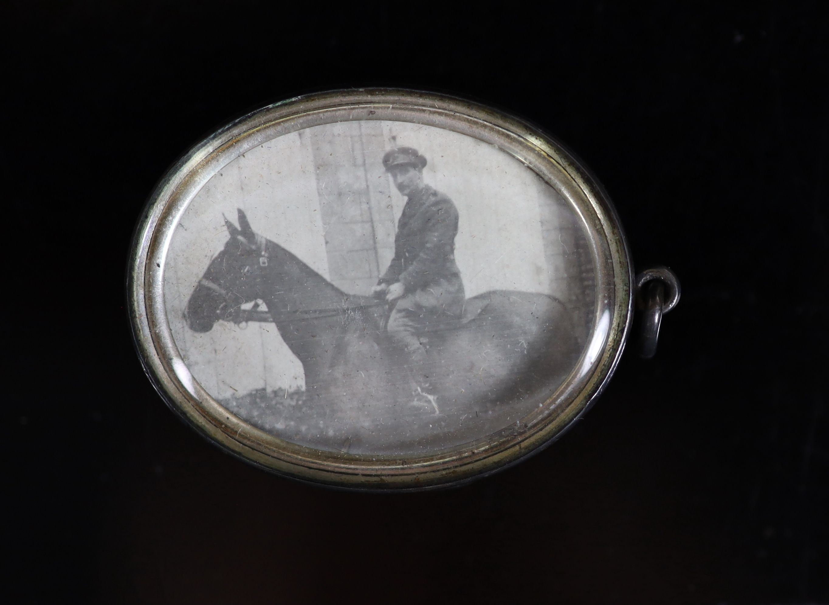 An early 20th century silver, rock crystal? and enamel set 'Central Indian Horse' cavalry regiment oval pendant locket